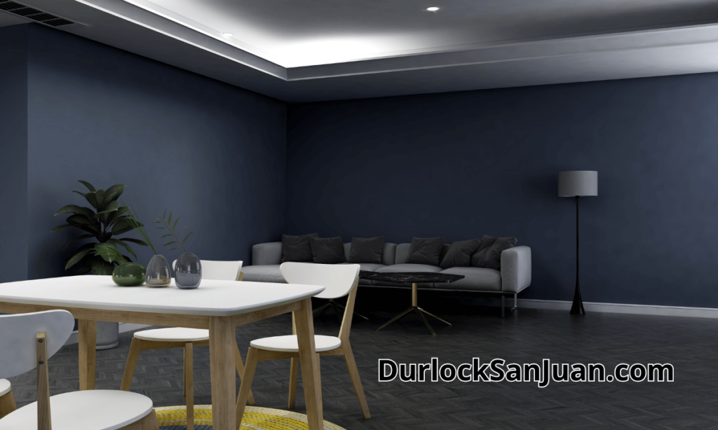 "Espacio minimalista con mesa moderna, paredes en durlock azul francia, techo blanco con luminaria LED y planta verde de interior."